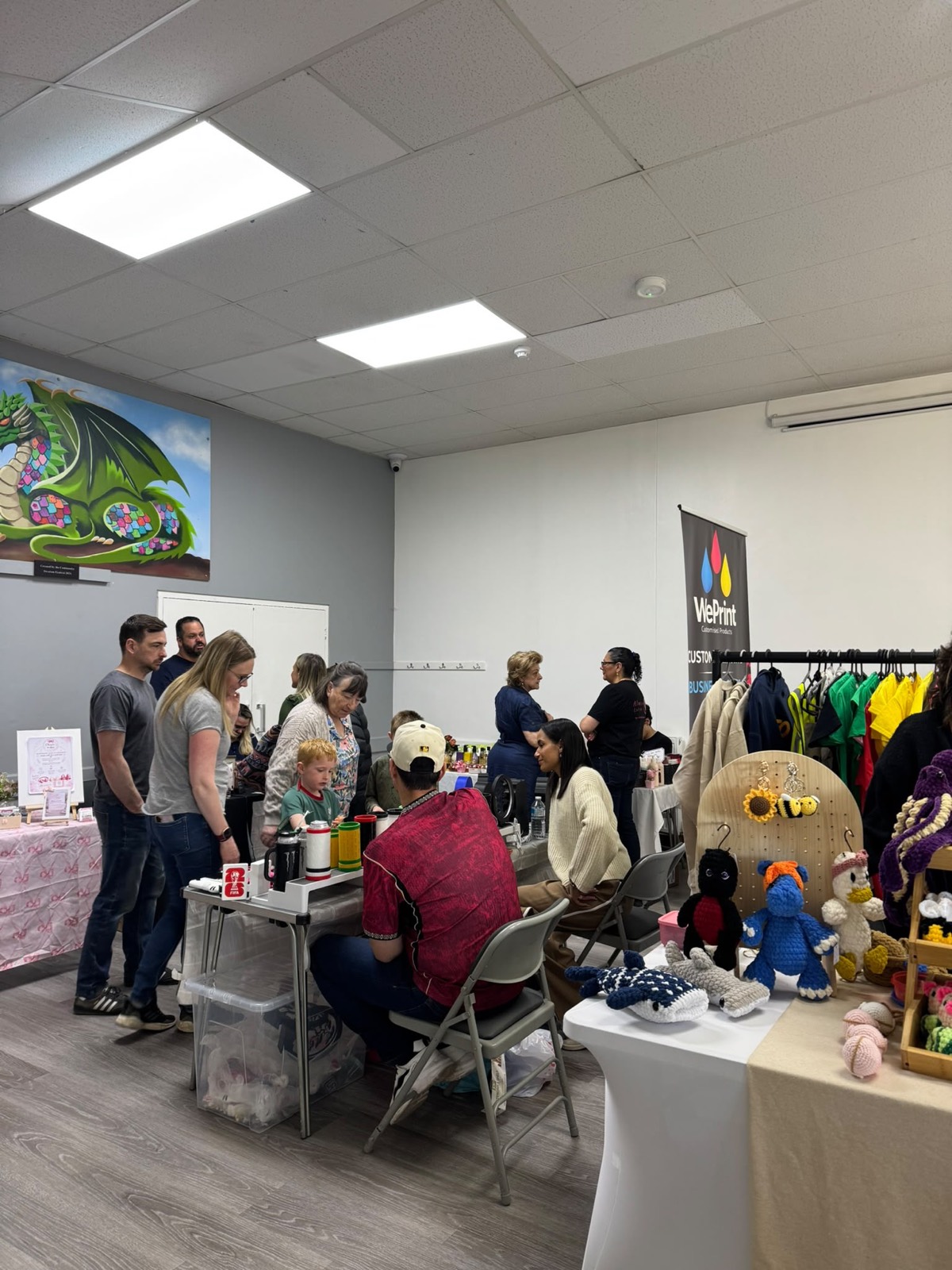 Families browsing stalls across the hall