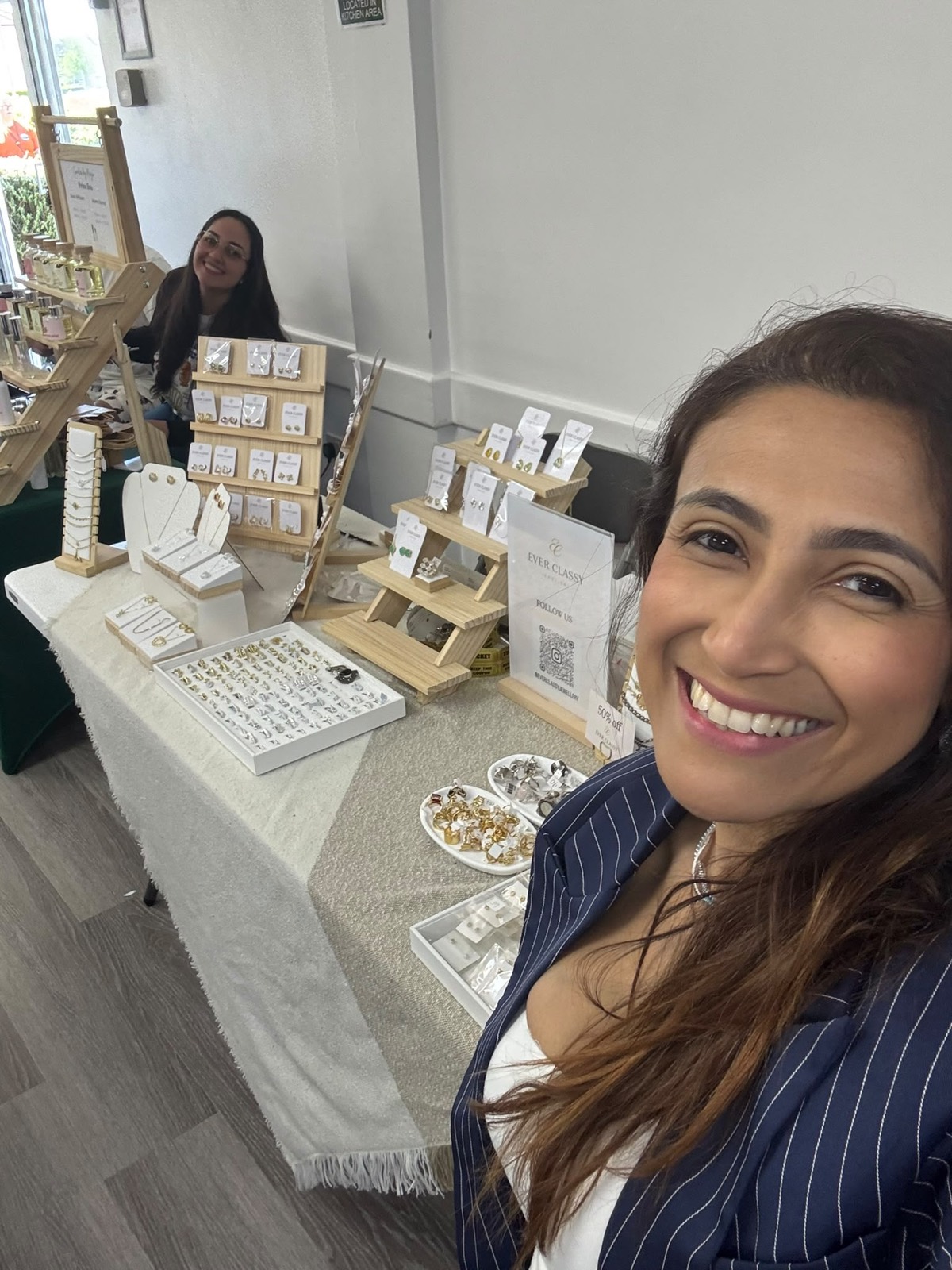 Exhibitor smiling in front of her jewellery stall
